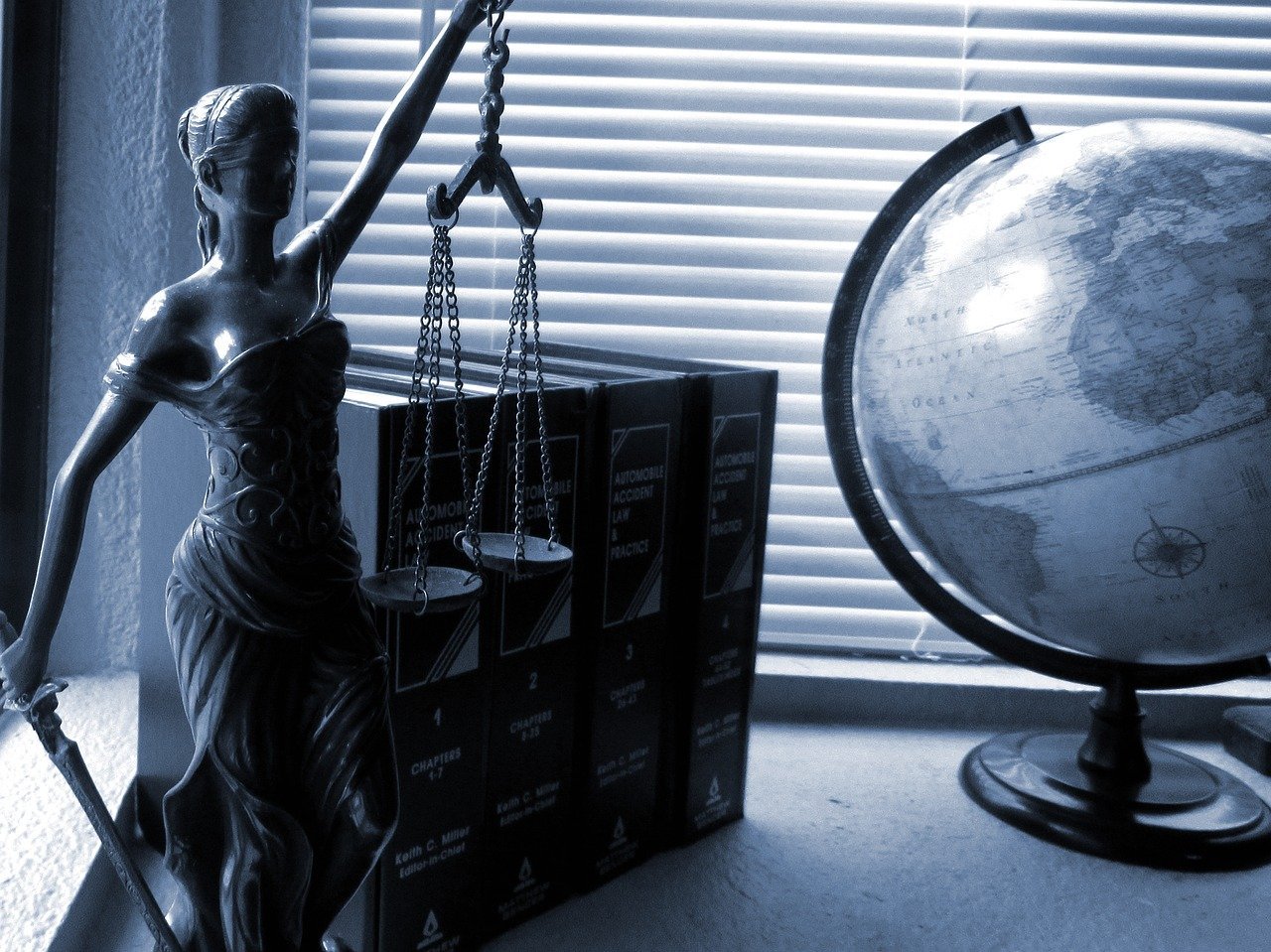 blind justice statuette and books